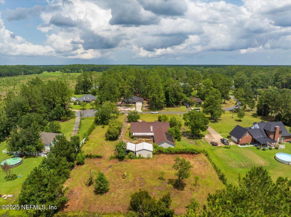 55056 Yellow Jacket Drive Callahan, FL 32011 - Photo 23 of 31 a view of a yard with swimming pool and outdoor seating