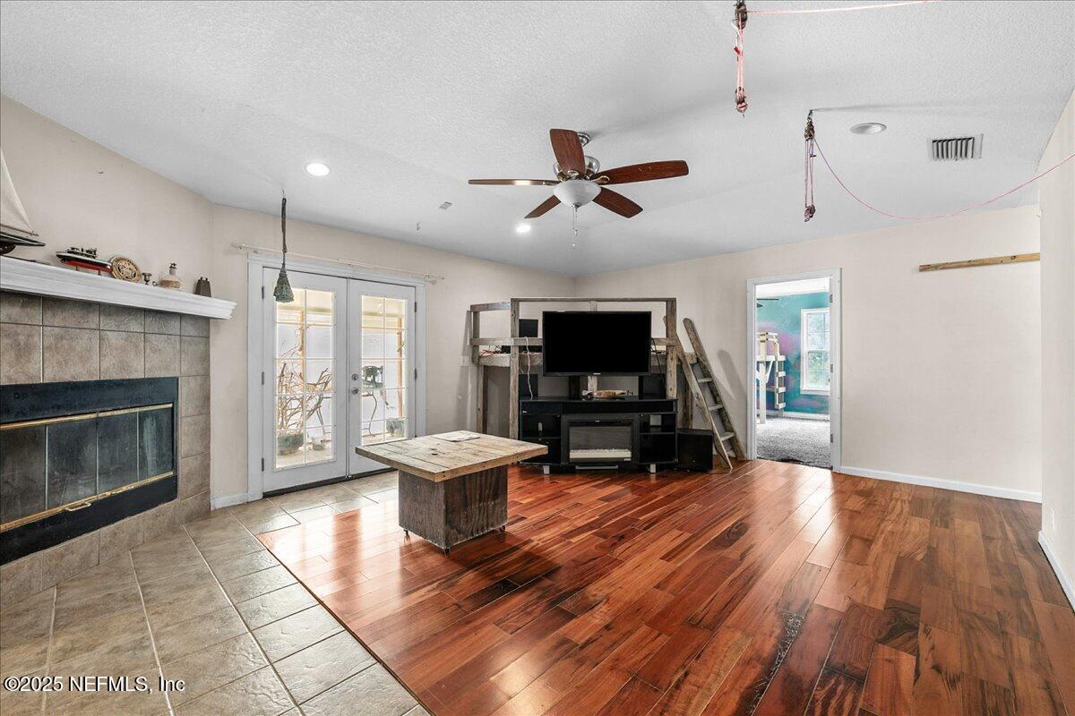 55056 Yellow Jacket Drive Callahan, FL 32011 - Photo 4 of 31 a living room with furniture a fireplace and a flat screen tv