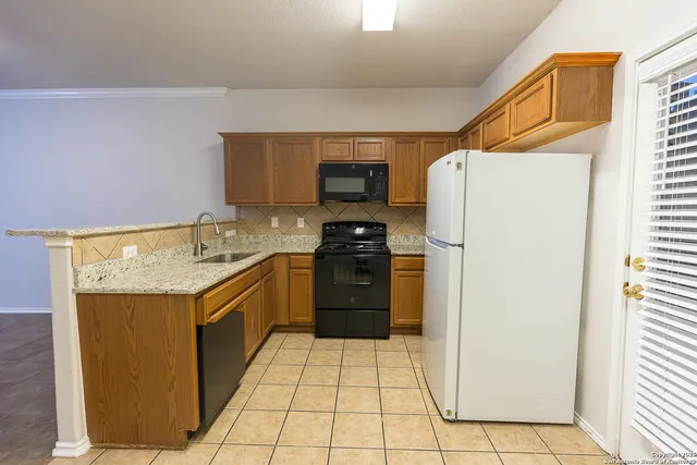 a kitchen with a refrigerator sink and stove