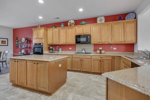a kitchen with stainless steel appliances granite countertop a sink and cabinets