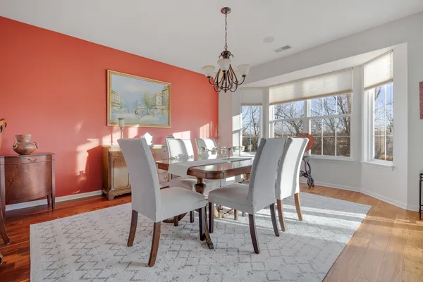 a view of a dining room with furniture window and wooden floor