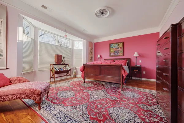 a bedroom with furniture and a rug