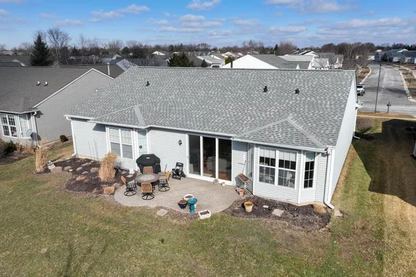 an aerial view of a house with sitting area and garden