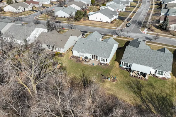 an aerial view of residential houses with outdoor space