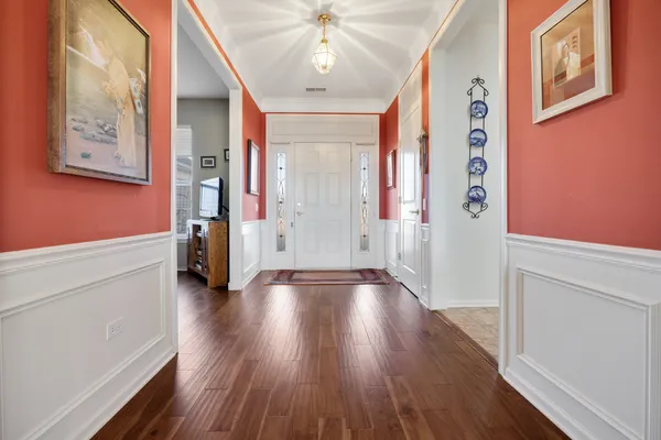 a view of an entryway with wooden floor