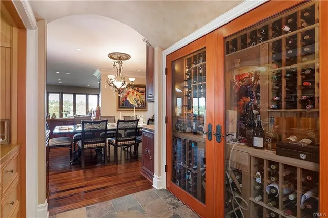 a open kitchen with stainless steel appliances granite countertop a table chairs and wooden floors