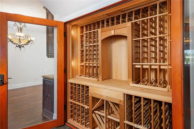a living room with furniture a flat screen tv and floor to ceiling window