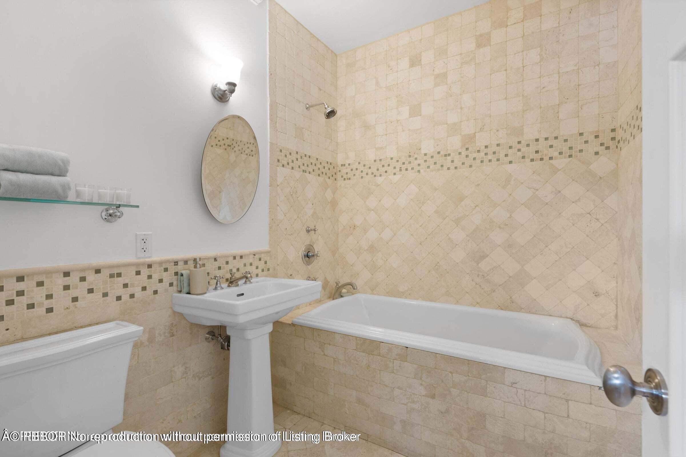 265 List Road Palm Beach, FL 33480 - Photo 16 of 21 a bathroom with a sink a toilet and a mirror