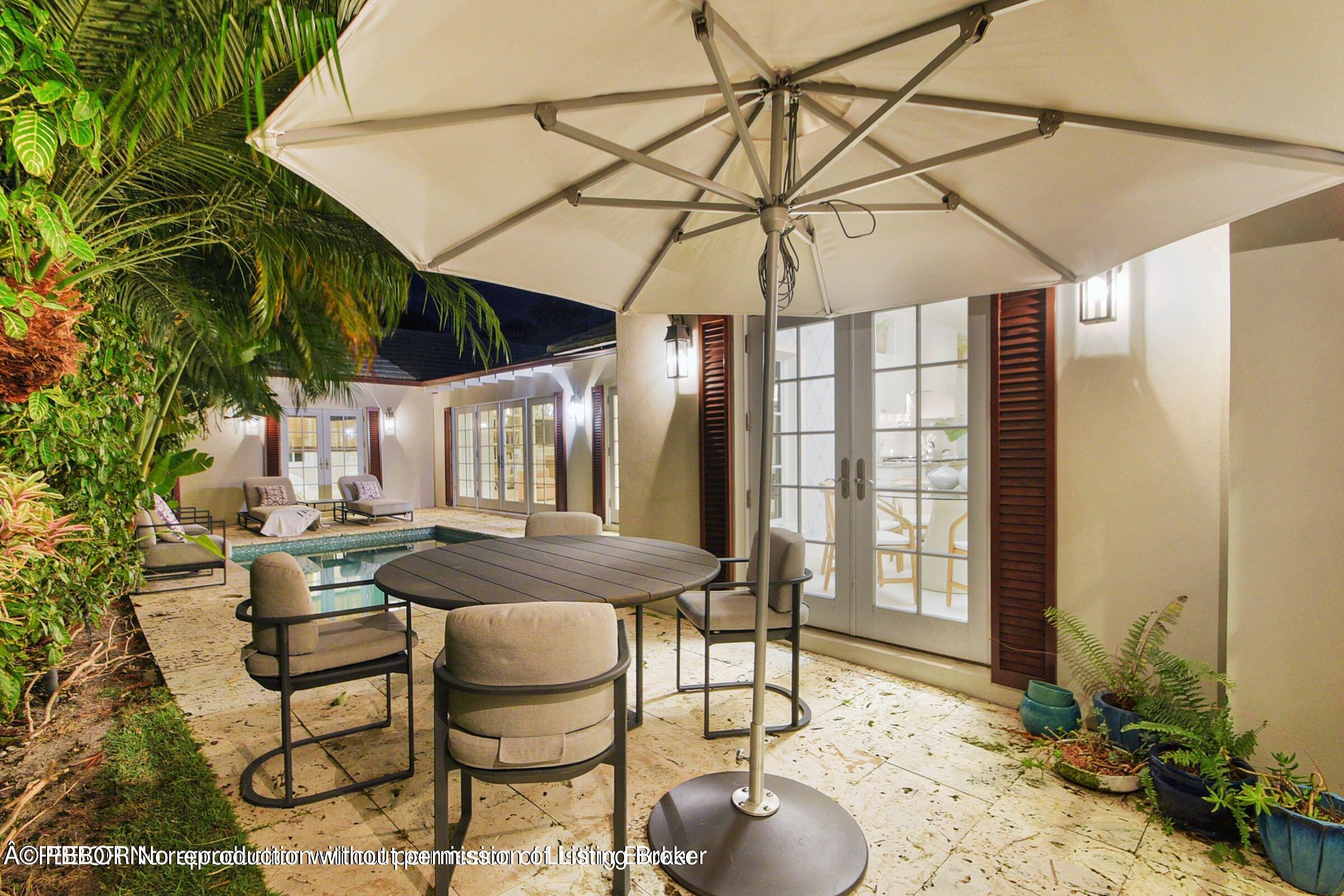 265 List Road Palm Beach, FL 33480 - Photo 20 of 21 a patio with a table and chairs and potted plants