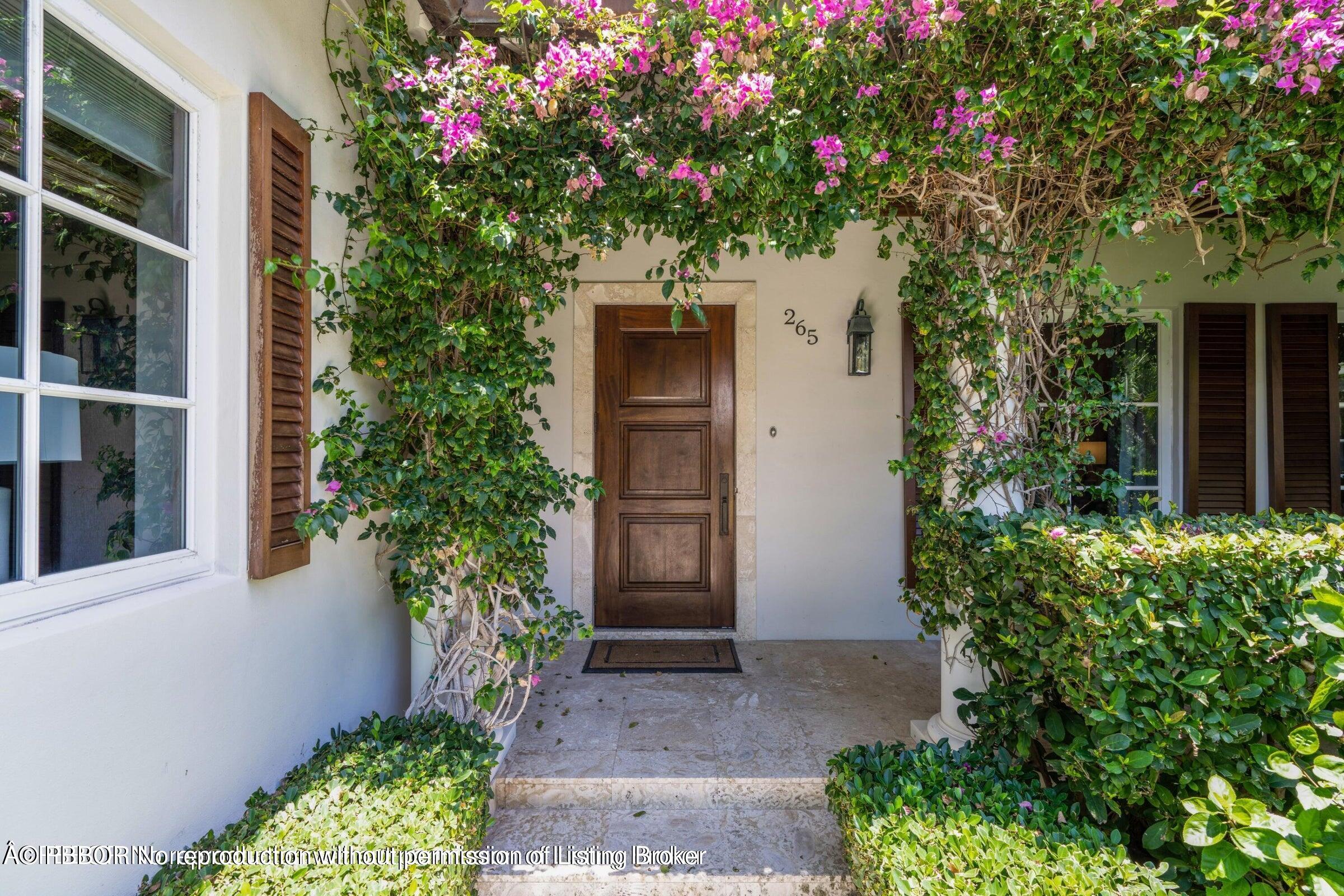 265 List Road Palm Beach, FL 33480 - Photo 3 of 21 front view of a house with a yard