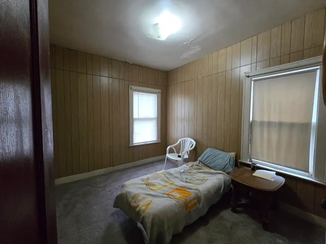 a bedroom with a bed and a window