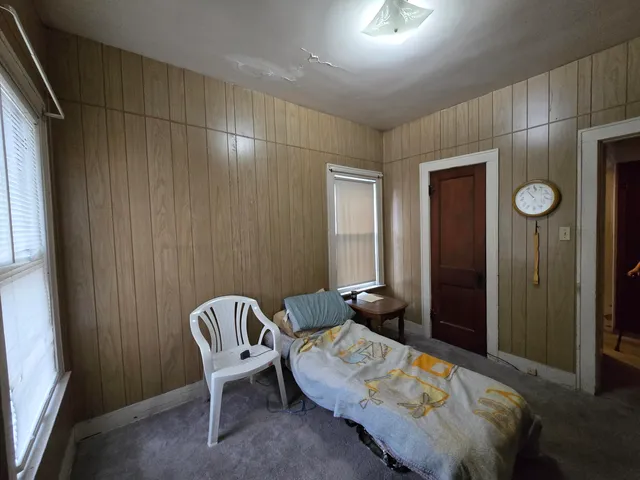 a bedroom with a bed and a chair