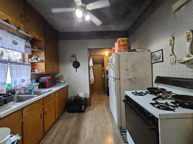 a kitchen with stove a sink and refrigerator