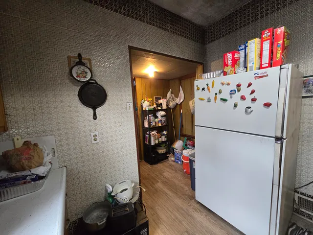 a white refrigerator freezer sitting inside of a kitchen