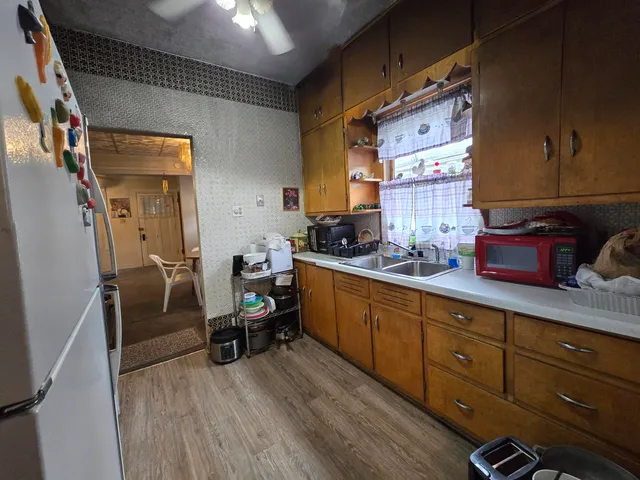 a kitchen with sink cabinets and wooden floor