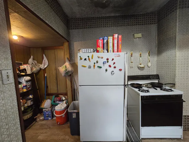 a white refrigerator freezer sitting inside of a kitchen