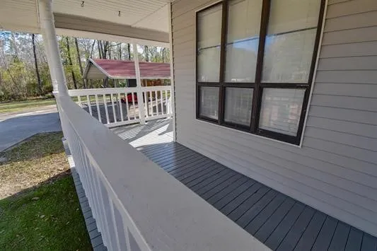 a view of balcony with wooden floor
