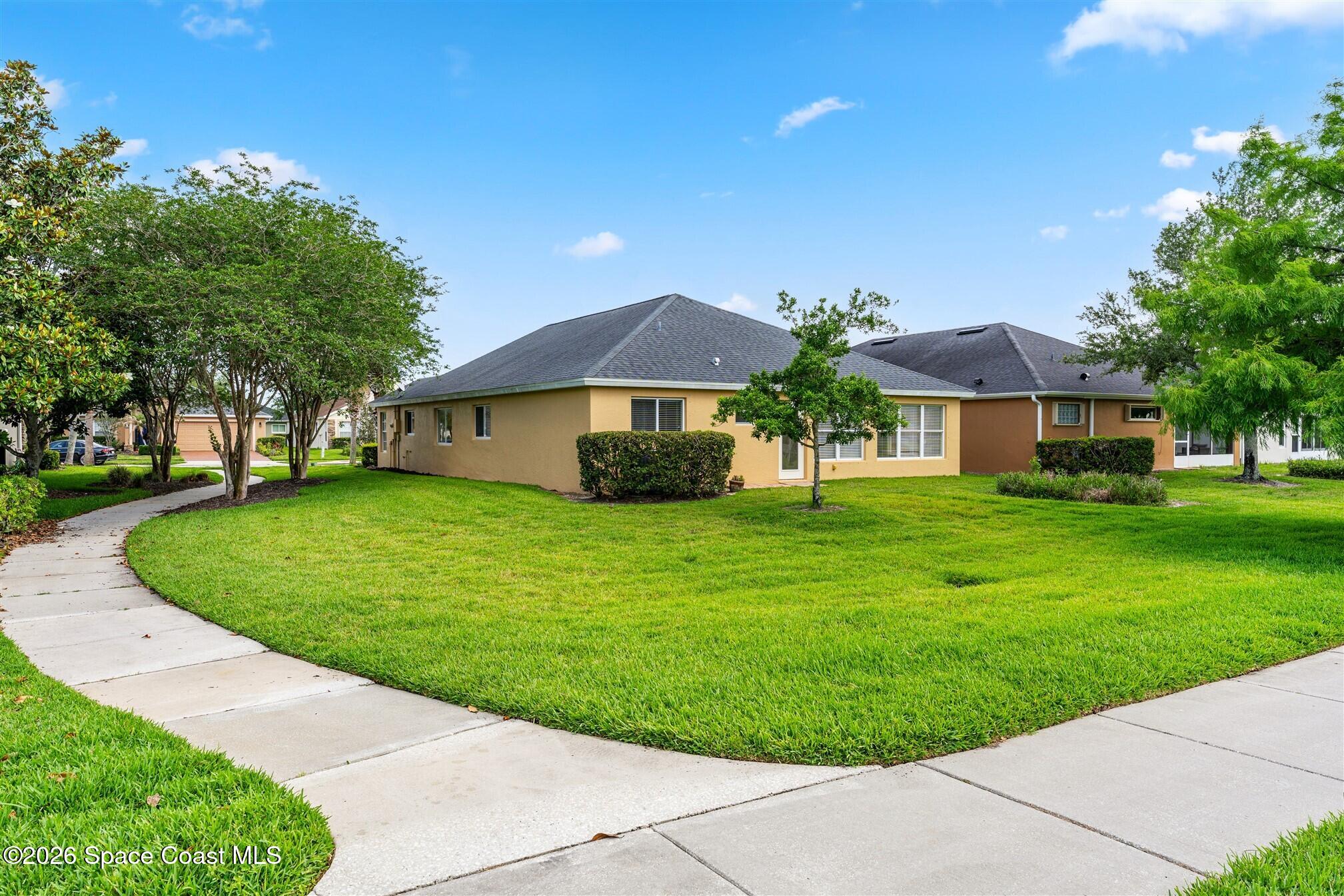 6904 Renshaw Drive Melbourne, FL 32940 - Photo 35 of 46 a front view of a house with a yard