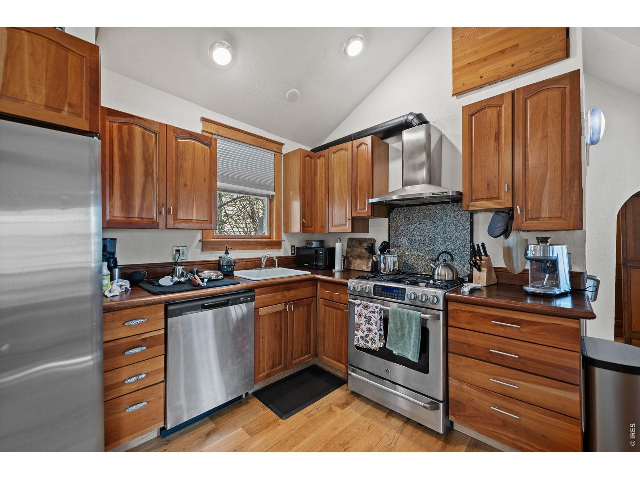 3005 6th Street Boulder, CO 80304 - Photo 19 of 41 a kitchen with stainless steel appliances granite countertop a stove a sink dishwasher and cabinets with wooden floor