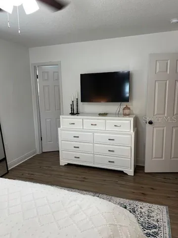 a bed sitting in a bedroom next to a window