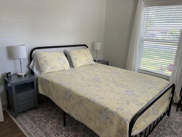 an outdoor sitting area with furniture and umbrella