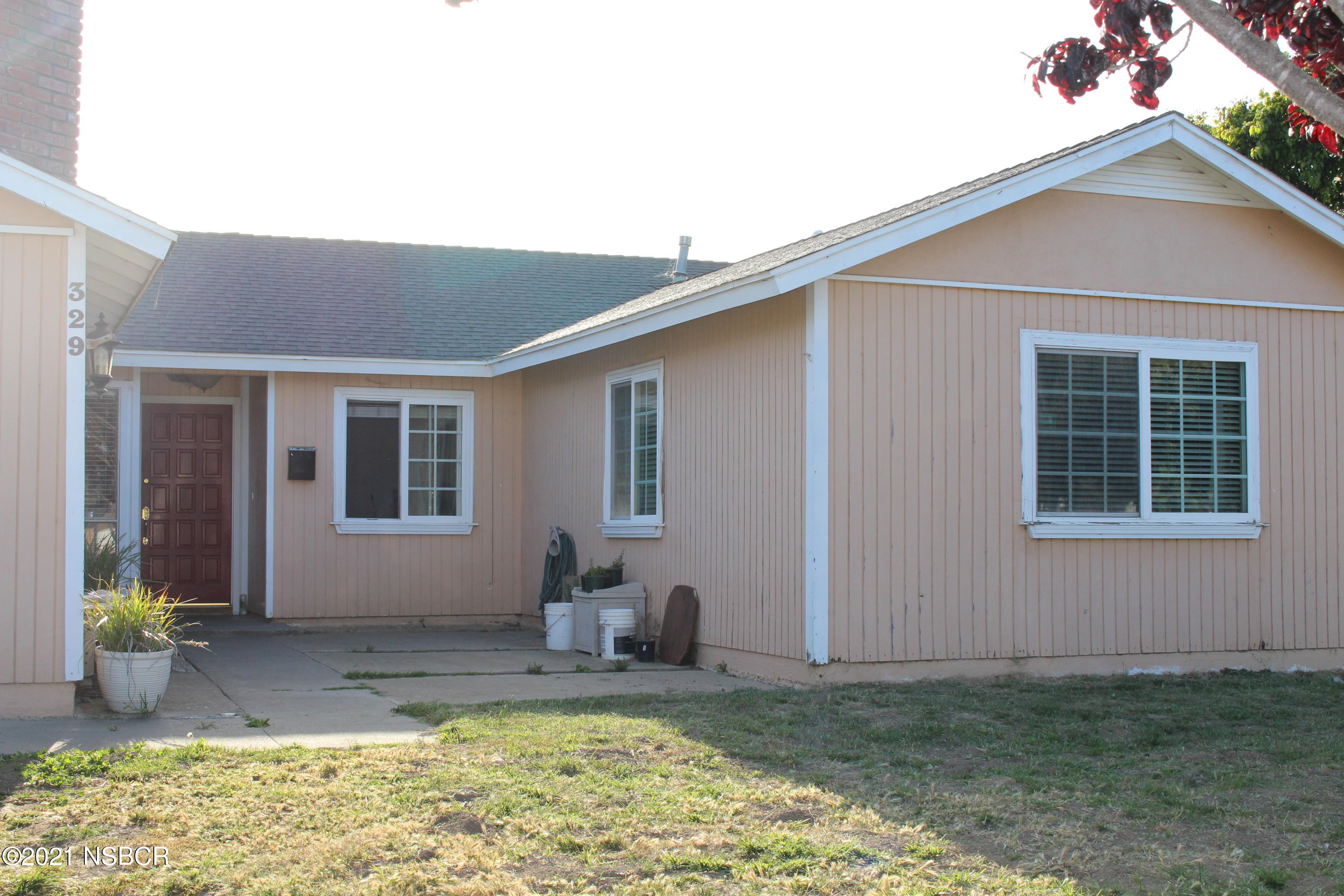 329 North X Street Lompoc, CA 93436 - Photo 1 of 6 a view of a house with backyard and sitting area