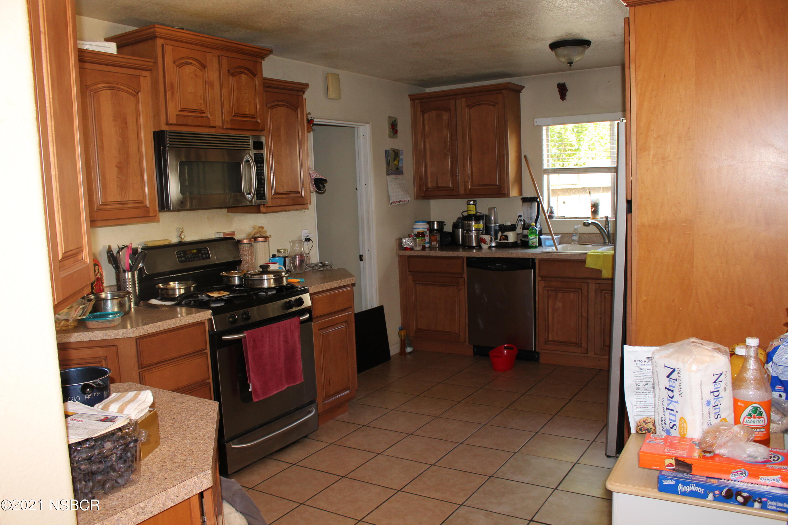 329 North X Street Lompoc, CA 93436 - Photo 4 of 6 a kitchen with stainless steel appliances granite countertop a stove and a refrigerator