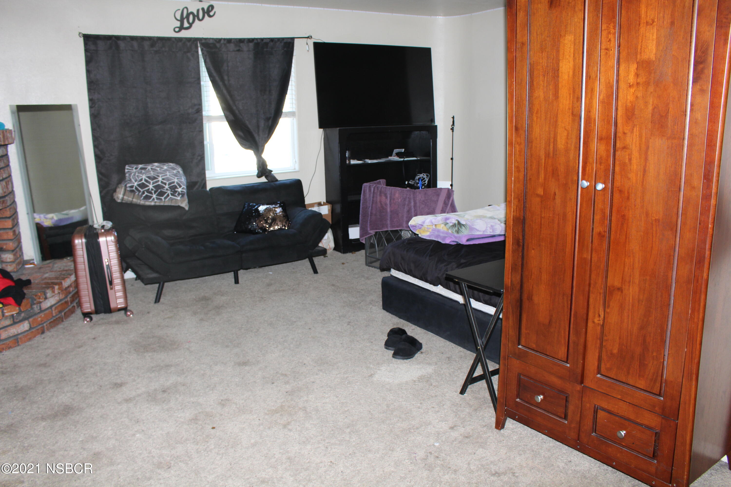 329 North X Street Lompoc, CA 93436 - Photo 5 of 6 a living room with furniture and a window