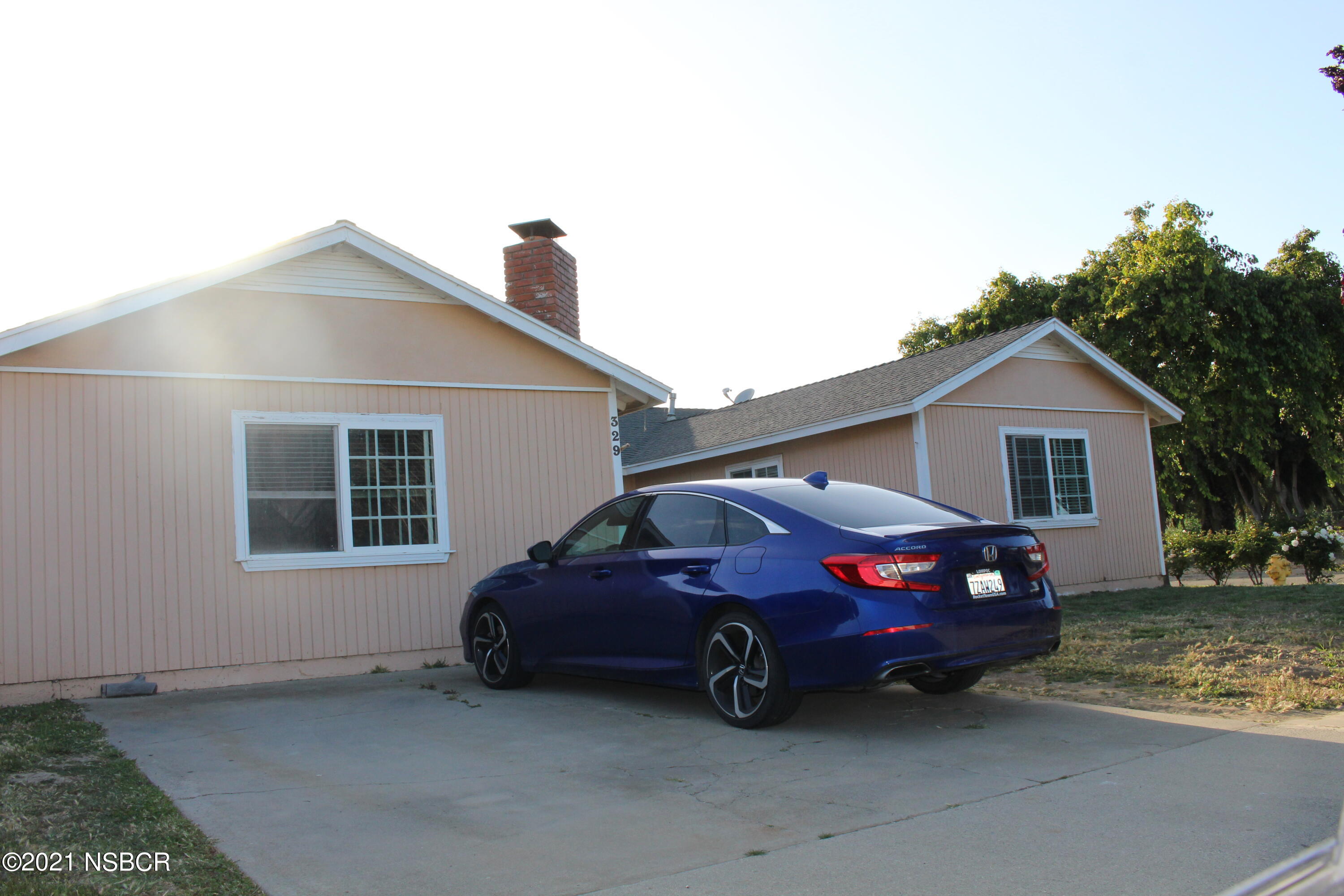 329 North X Street Lompoc, CA 93436 - Photo 6 of 6 a car parked in front of a house