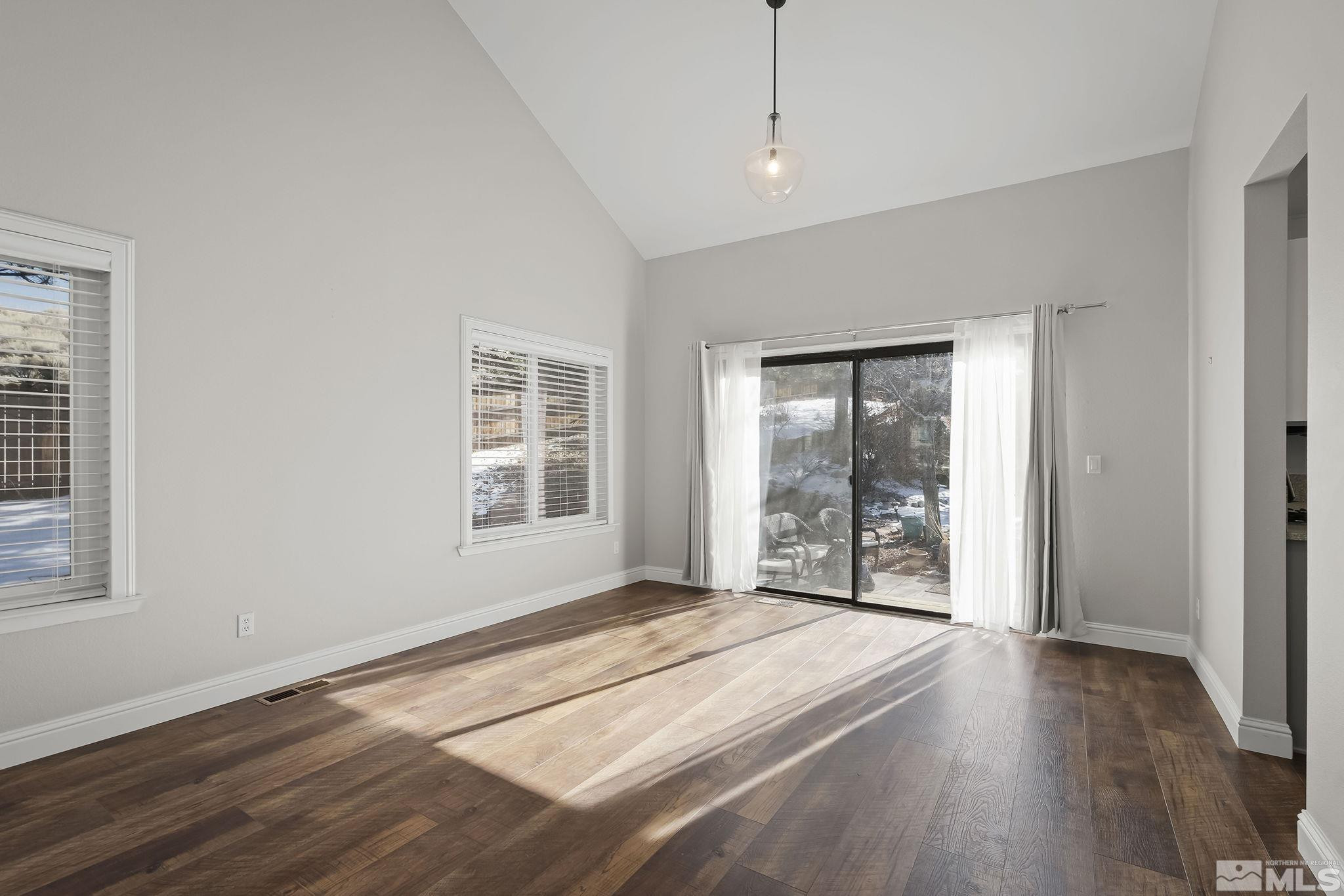 5380 Simons Drive Reno, NV 89523 - Photo 9 of 39 a view of an empty room with wooden floor and a window