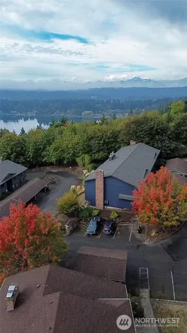 an aerial view of residential houses with outdoor space and ocean view