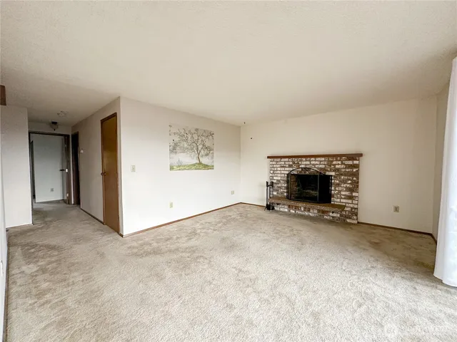 an empty room with furniture and a fireplace