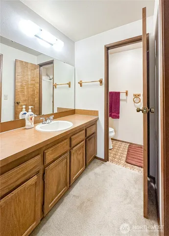 a spacious bathroom with a double vanity sink and a mirror