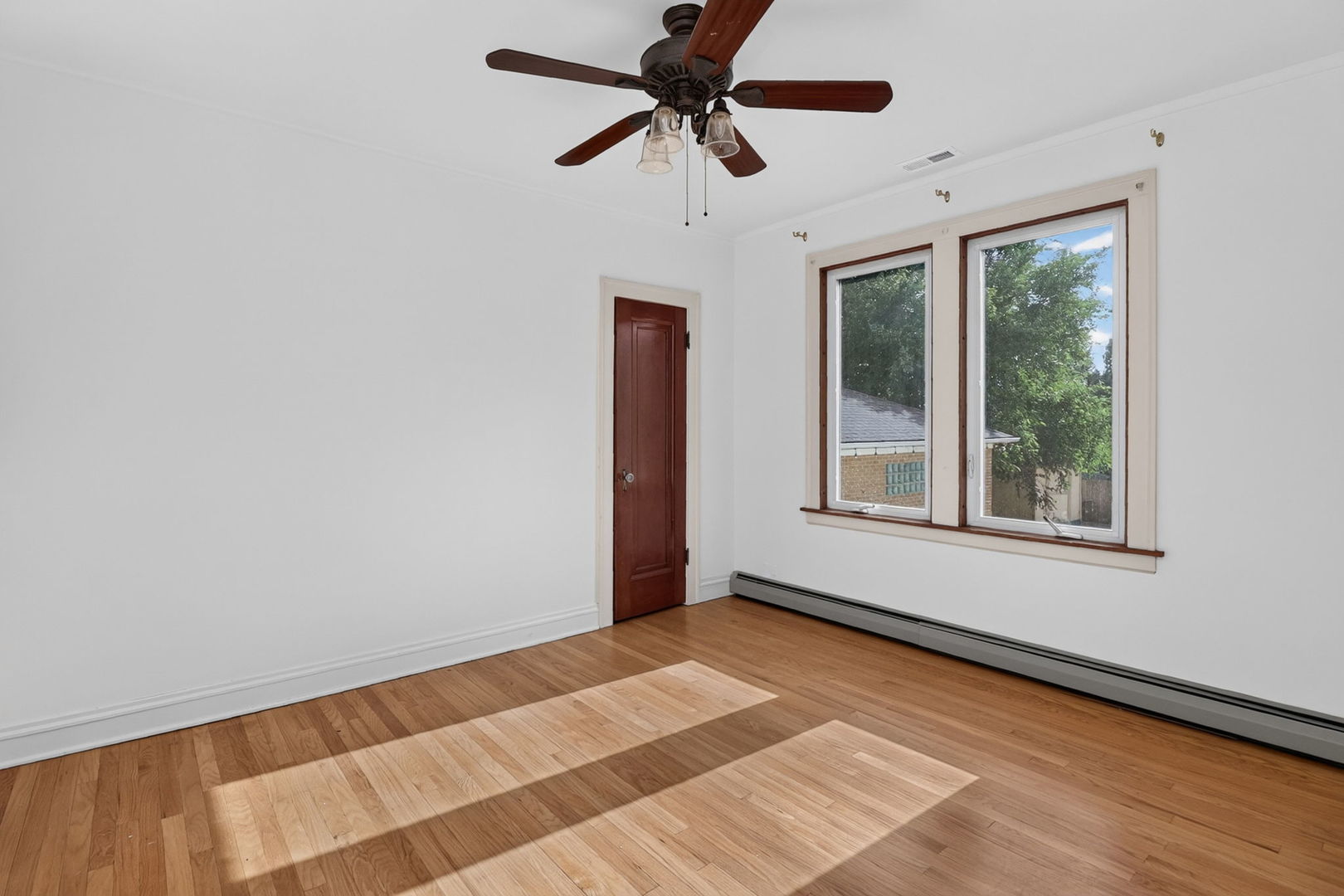 708 McCarthy Road Lemont, IL 60439 - Photo 11 of 14 a view of a room with a ceiling fan and window