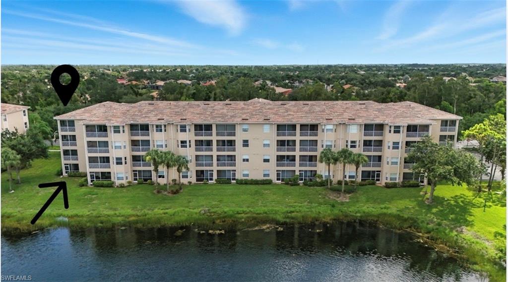 8570 Kingbird Loop, Unit 520 Estero, FL 33967 - Photo 28 of 37 View of apartment building / complex featuring a water view and view of wooded area