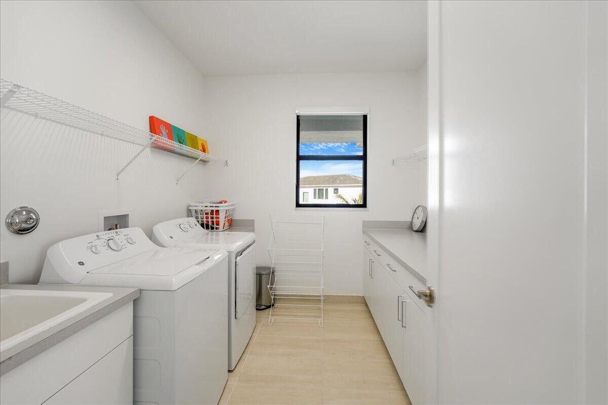 17496 Sparkling River Road Boca Raton, FL 33496 - Photo 24 of 36 a utility room with dryer and washer