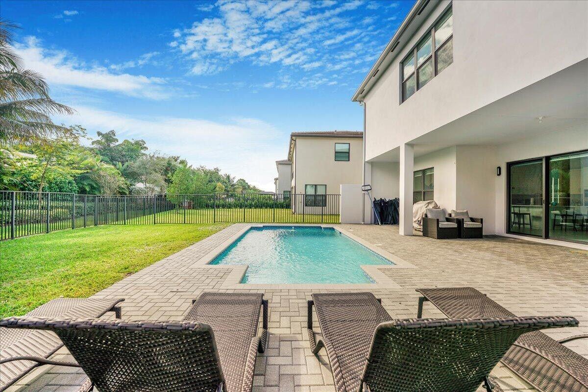 17496 Sparkling River Road Boca Raton, FL 33496 - Photo 27 of 36 a view of outdoor space yard deck patio and swimming pool