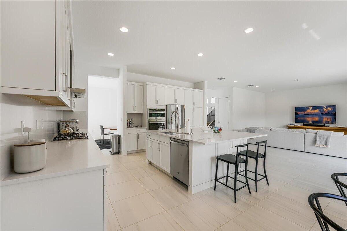 17496 Sparkling River Road Boca Raton, FL 33496 - Photo 4 of 36 a kitchen with refrigerator and cabinets