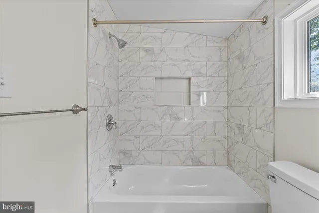 a bathroom with a shower and a toilet