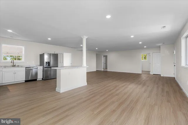 a view of kitchen with furniture and wooden floor