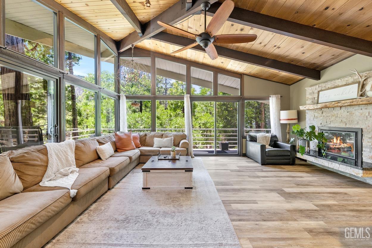 Undisclosed Address Wofford Heights, CA 93285 - Photo 16 of 35 a living room with furniture large windows and a fireplace