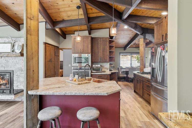 Undisclosed Address Wofford Heights, CA 93285 - Photo 19 of 35 a view of kitchen island with granite countertop lots of wooden furniture