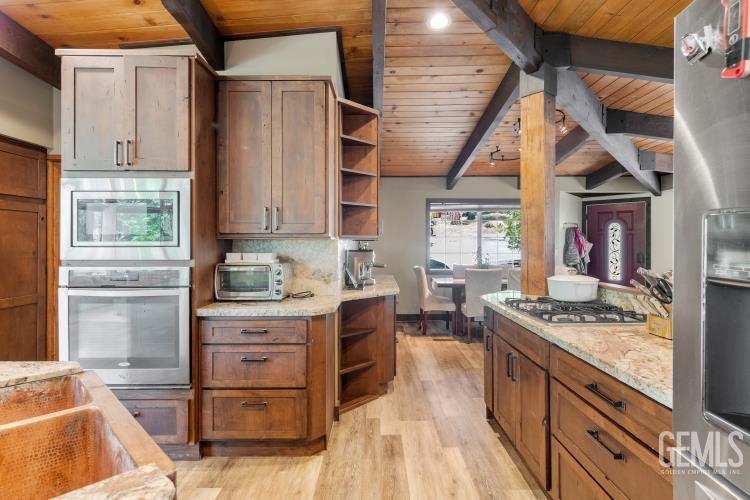 Undisclosed Address Wofford Heights, CA 93285 - Photo 21 of 35 a kitchen with stainless steel appliances granite countertop a stove and a refrigerator