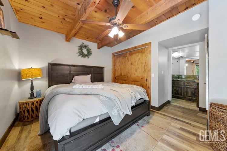 Undisclosed Address Wofford Heights, CA 93285 - Photo 25 of 35 a bedroom with a bed and a chandelier