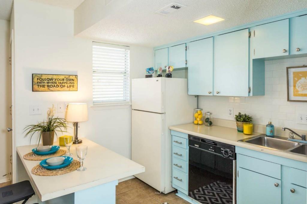 3405 Helms Street, Unit 101 Austin, TX 78705 - Photo 3 of 5 a kitchen with stainless steel appliances granite countertop a sink a refrigerator and a stove