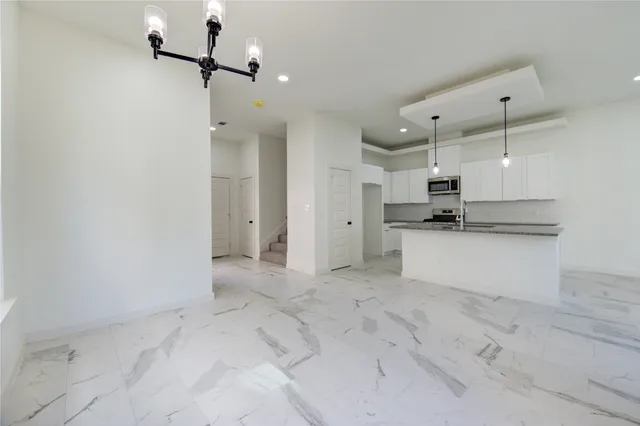 a view of a kitchen with a sink and stainless steel appliances