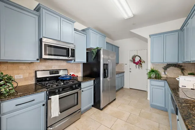 a kitchen with a refrigerator stove and microwave