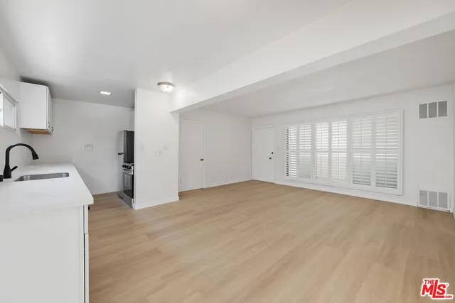 a kitchen with a sink and a refrigerator