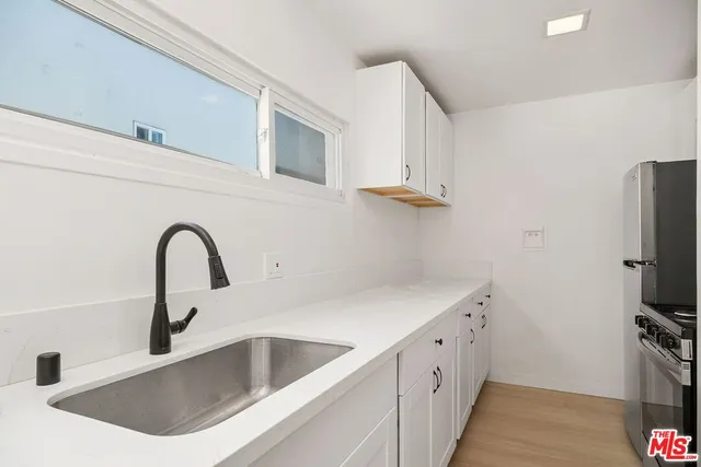 a kitchen with a stove and a refrigerator