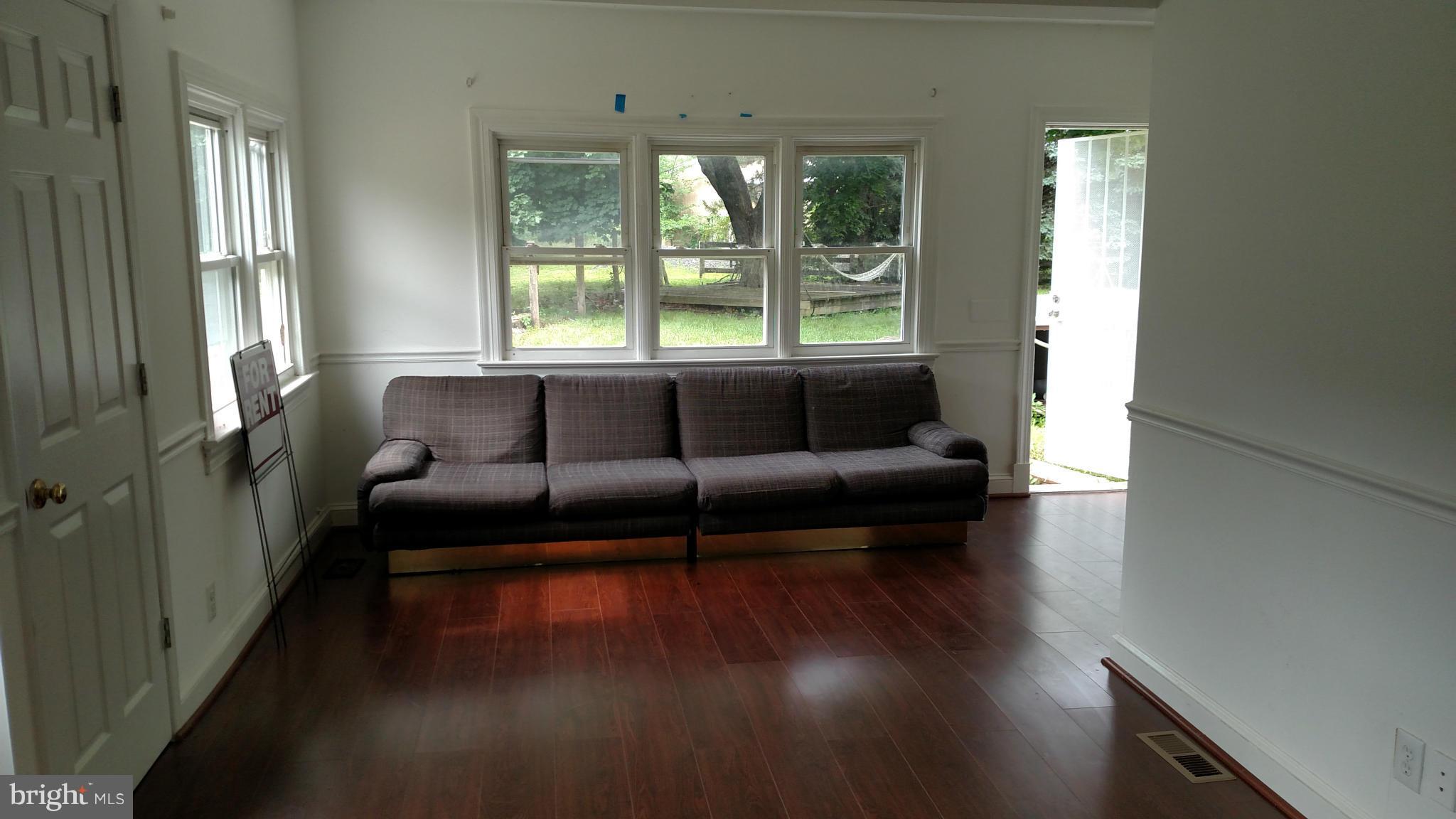23820 Frederick Road Clarksburg, MD 20871 - Photo 5 of 7 a living room with furniture and a large window